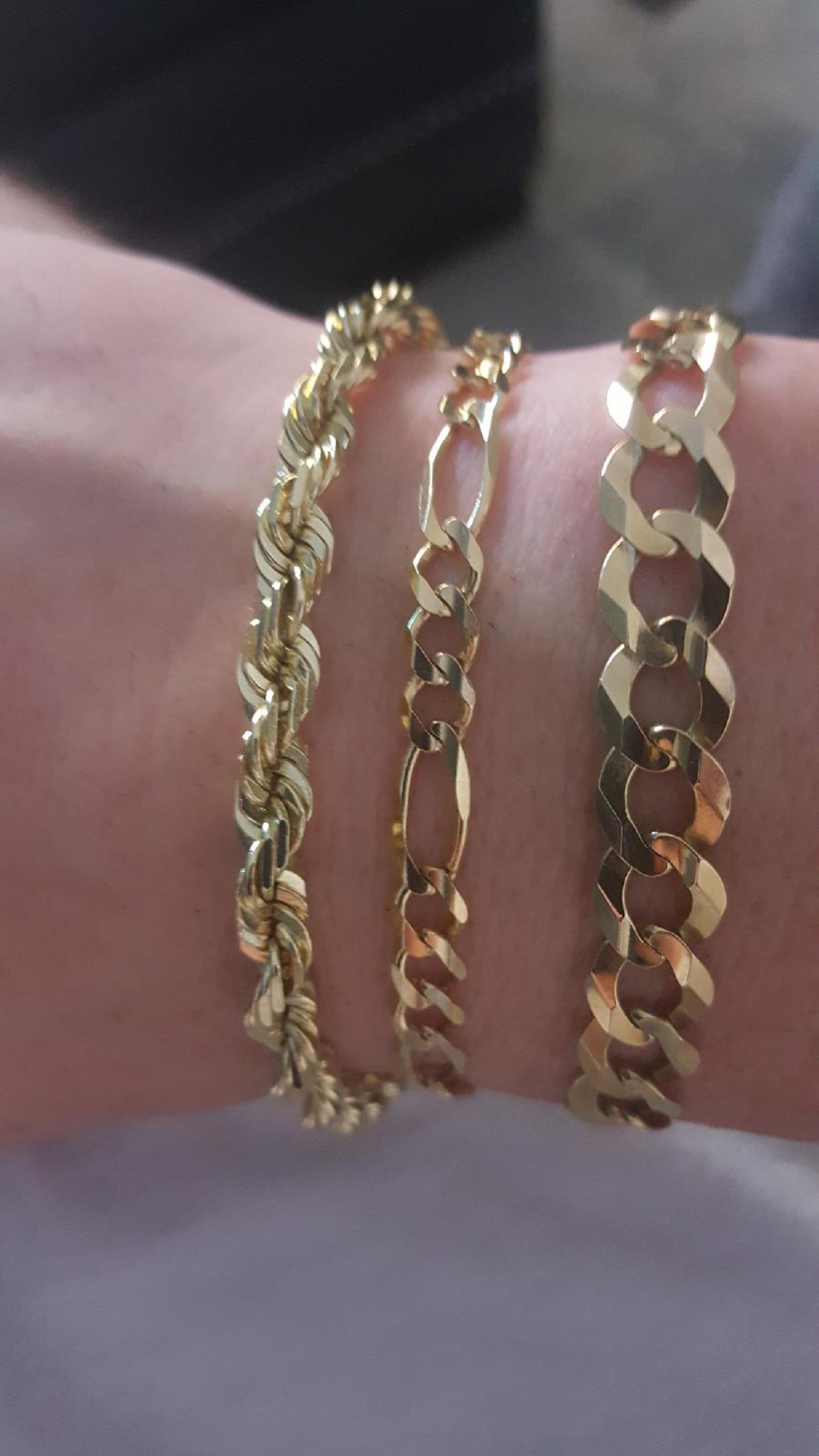Yellow gold rope, Figaro and Cuban link chains, photographed at Mint Jewelers
