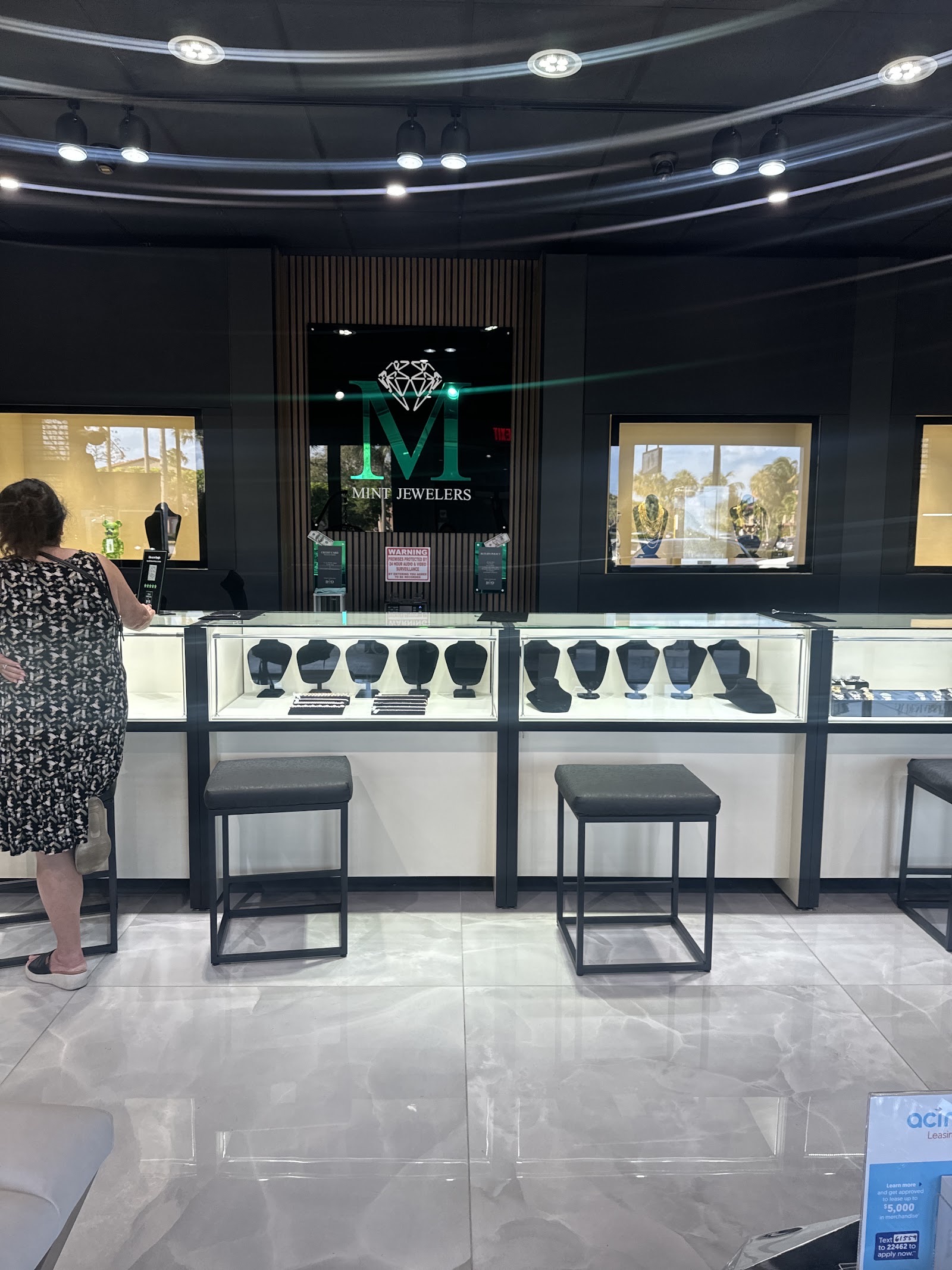 Inside Mint Jewelers: the glass counters under the mint M sign